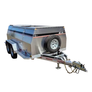 The Lynx 7 is a silver, dual-axle utility trailer with black accents and storage compartments—perfect for towing wildfire equipment in Canada. It has a front-mounted spare tire and features designed specifically for firefighters.