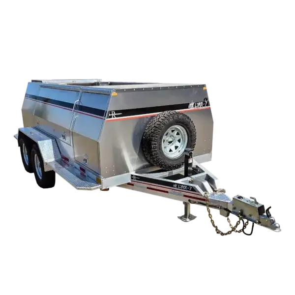 The Lynx 7 is a silver, dual-axle utility trailer with black accents and storage compartments—perfect for towing wildfire equipment in Canada. It has a front-mounted spare tire and features designed specifically for firefighters.